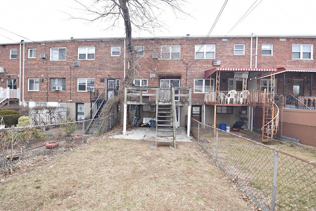 back of property with brick siding and stairway