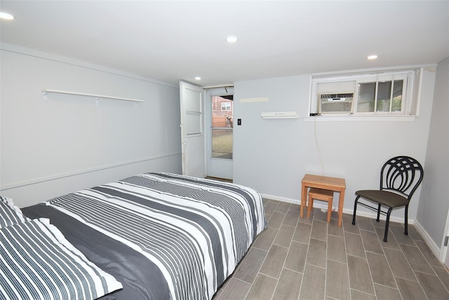 bedroom featuring wood finished floors, cooling unit, recessed lighting, and baseboards