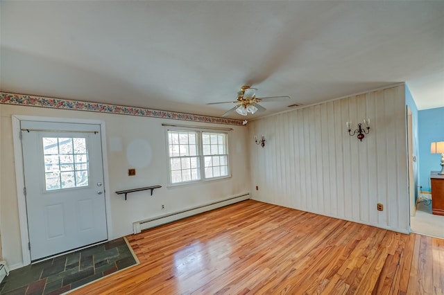 entryway featuring a ceiling fan, plenty of natural light, light wood-style floors, and a baseboard radiator