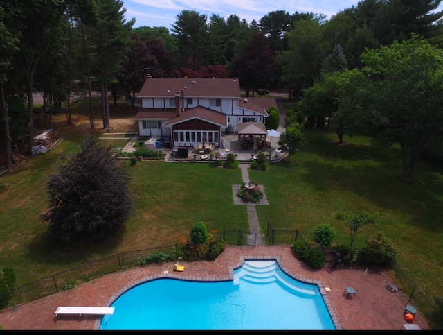 exterior space featuring a patio, fence, a fenced in pool, a yard, and a gazebo