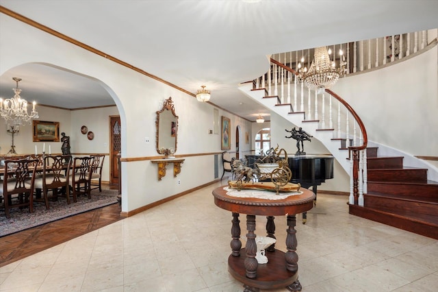 entrance foyer with a chandelier, arched walkways, and stairs