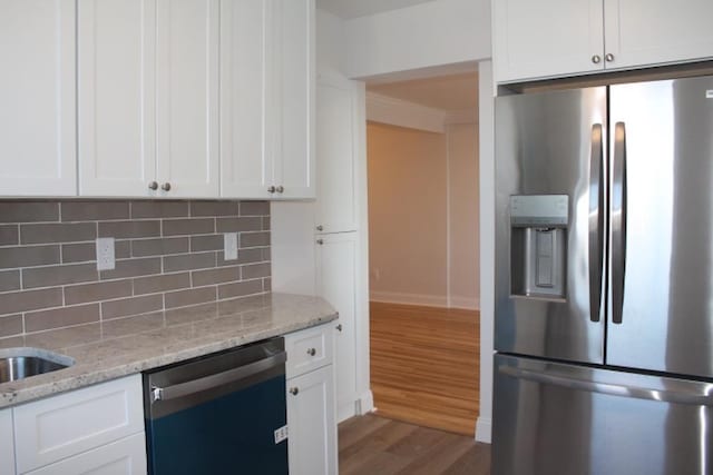 kitchen with backsplash, dishwasher, stainless steel refrigerator with ice dispenser, wood finished floors, and white cabinetry