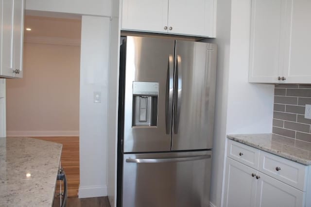 kitchen with decorative backsplash, white cabinets, stainless steel fridge, and dark wood-style flooring