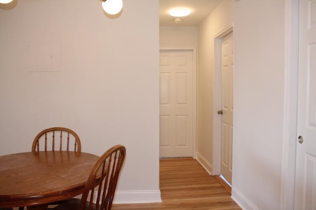 dining room with light wood-style flooring and baseboards