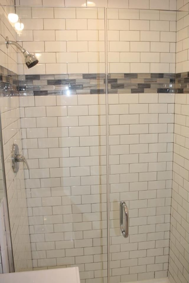 full bath featuring a shower stall