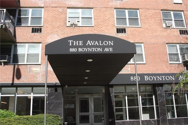 entrance to property featuring brick siding