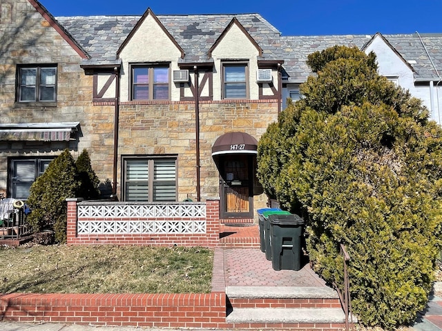 view of front of home with a high end roof and stone siding