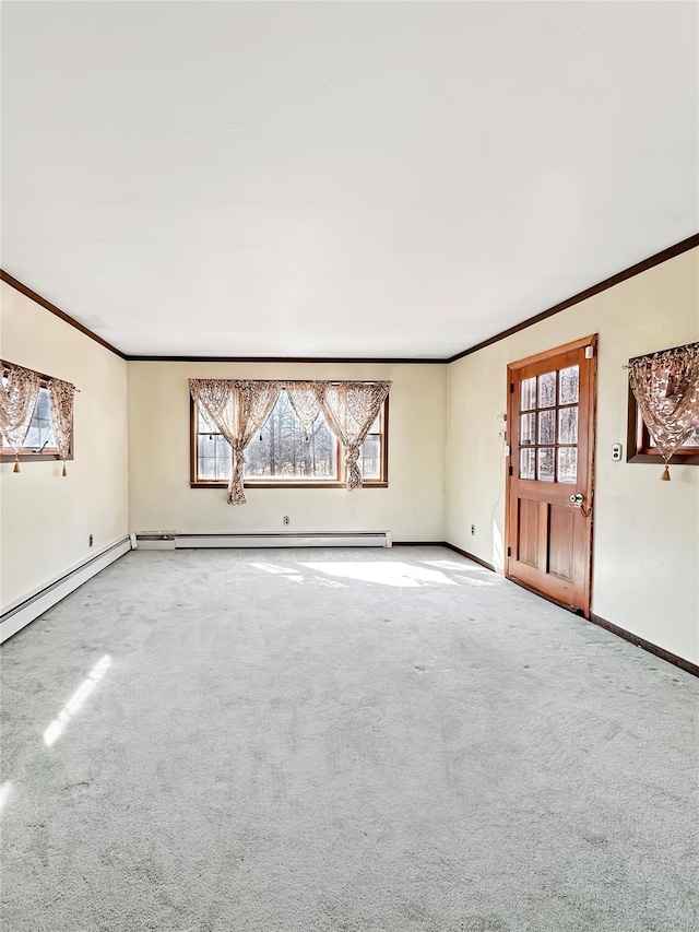 unfurnished living room with carpet flooring, baseboards, and crown molding