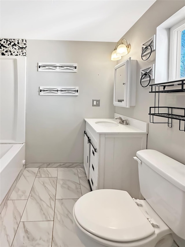 full bathroom featuring marble finish floor, toilet, and vanity