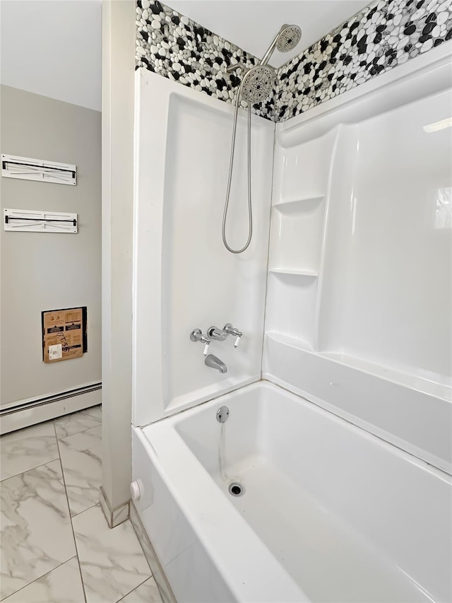 bathroom featuring marble finish floor, a baseboard heating unit, and bathtub / shower combination