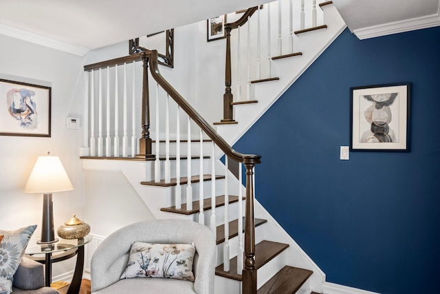 stairway featuring baseboards and ornamental molding