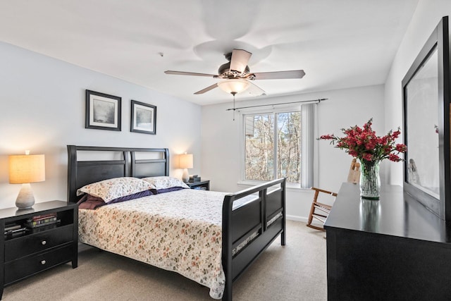 carpeted bedroom featuring baseboards and ceiling fan