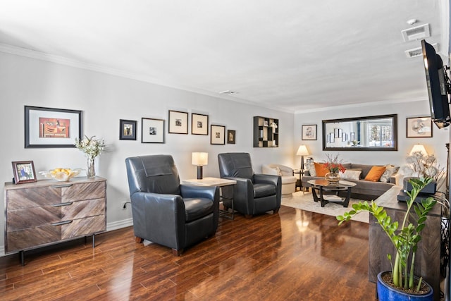 living room with visible vents, wood finished floors, and crown molding