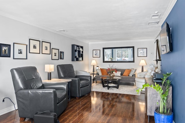 living room with visible vents, crown molding, baseboards, and wood finished floors