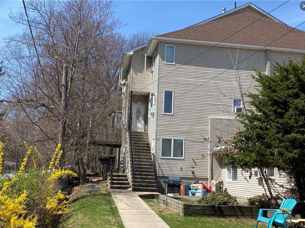 back of house featuring stairs