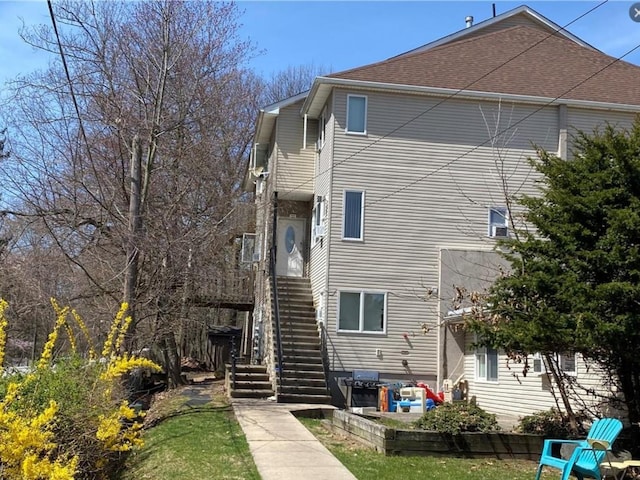 back of house featuring stairs