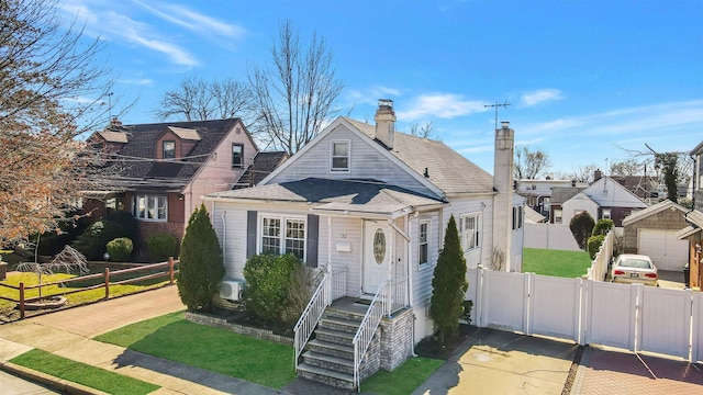 view of front of house with a gate, fence, and a chimney