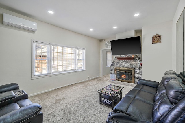 carpeted living room featuring a stone fireplace, recessed lighting, baseboards, and a wall unit AC