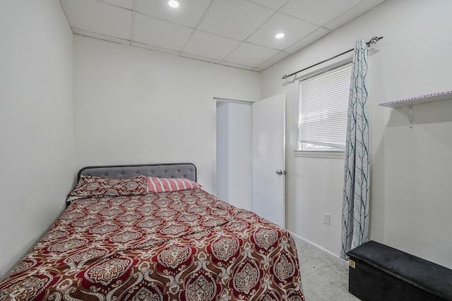 carpeted bedroom with recessed lighting and a drop ceiling