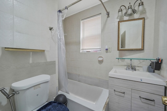 full bath featuring vanity, tile walls, shower / tub combo, and toilet