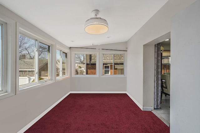 unfurnished sunroom featuring vaulted ceiling