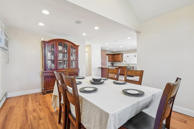 dining space featuring recessed lighting, light wood-type flooring, baseboards, and vaulted ceiling