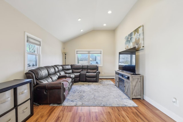 living area featuring recessed lighting, baseboards, light wood finished floors, a baseboard radiator, and lofted ceiling