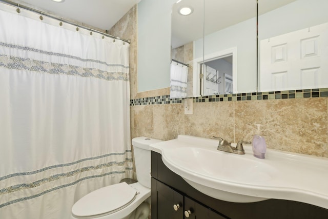 bathroom featuring vanity, tile walls, curtained shower, and toilet