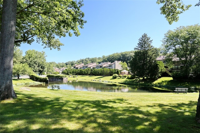 view of community with a lawn and a water view