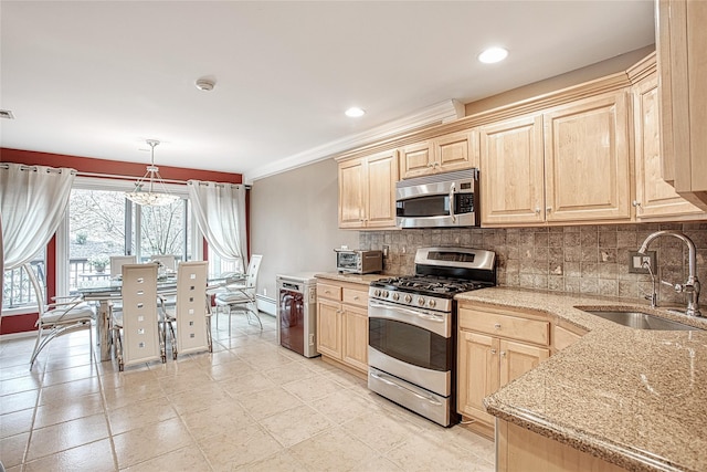 kitchen with a sink, stainless steel appliances, backsplash, and light brown cabinetry