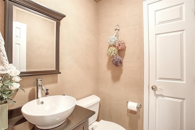 bathroom featuring toilet and vanity