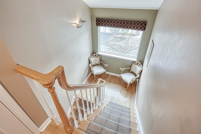 stairs featuring baseboards and wood finished floors