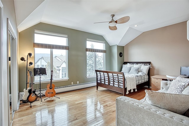 bedroom featuring hardwood / wood-style floors, lofted ceiling, ceiling fan, and a baseboard radiator