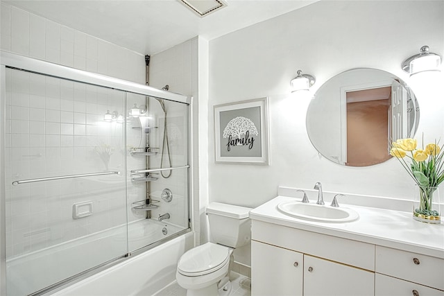 bathroom featuring shower / bath combination with glass door, toilet, and vanity