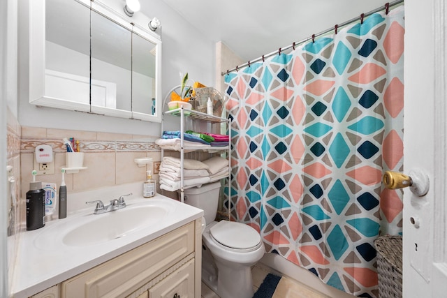 bathroom with curtained shower, toilet, tile walls, and vanity