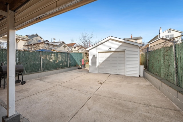 detached garage with fence and driveway