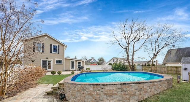 view of swimming pool featuring a fenced in pool, a patio, and a fenced backyard