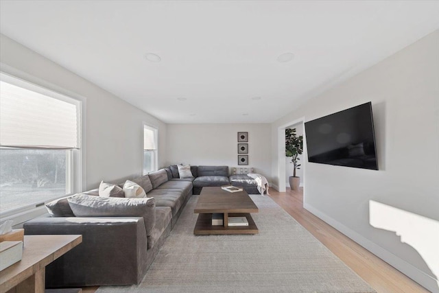 living area featuring light wood finished floors and baseboards