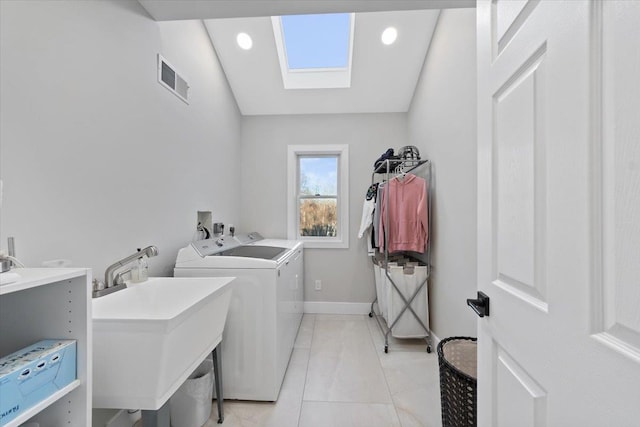 laundry room with visible vents, baseboards, laundry area, washer and dryer, and a sink