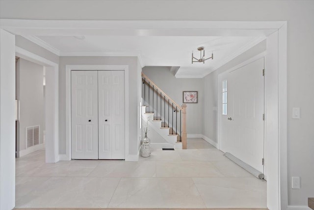 entrance foyer with stairs, baseboards, visible vents, and ornamental molding