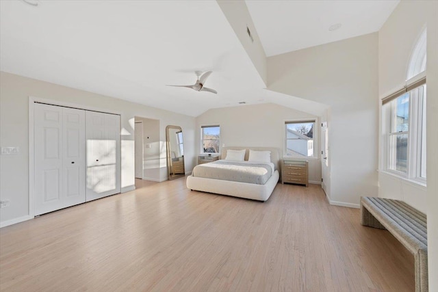 bedroom featuring visible vents, baseboards, vaulted ceiling, light wood-style floors, and a ceiling fan