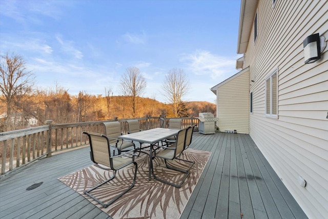 deck featuring area for grilling and outdoor dining area