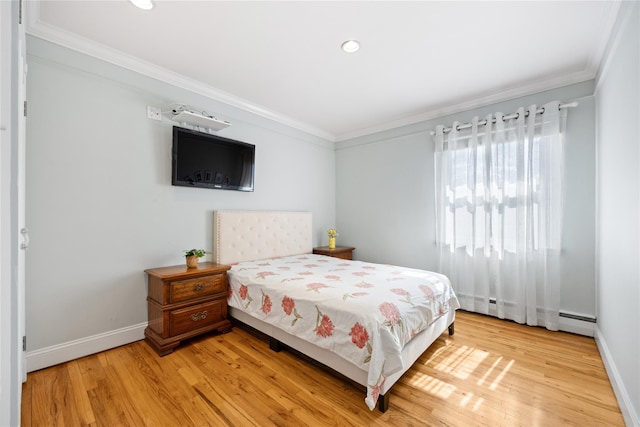 bedroom featuring light wood-style flooring, baseboards, and ornamental molding