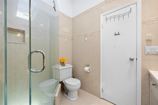 full bath with toilet, a stall shower, tile walls, tile patterned flooring, and vanity