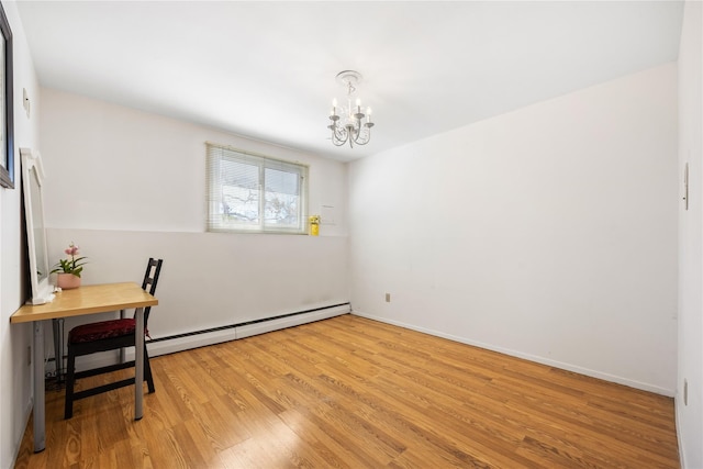 empty room with a baseboard radiator, wood finished floors, baseboards, and a chandelier