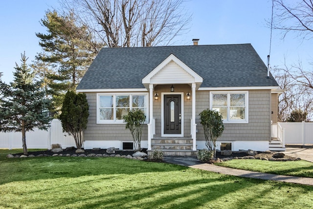 view of front of house featuring a front lawn, entry steps, fence, roof with shingles, and a chimney