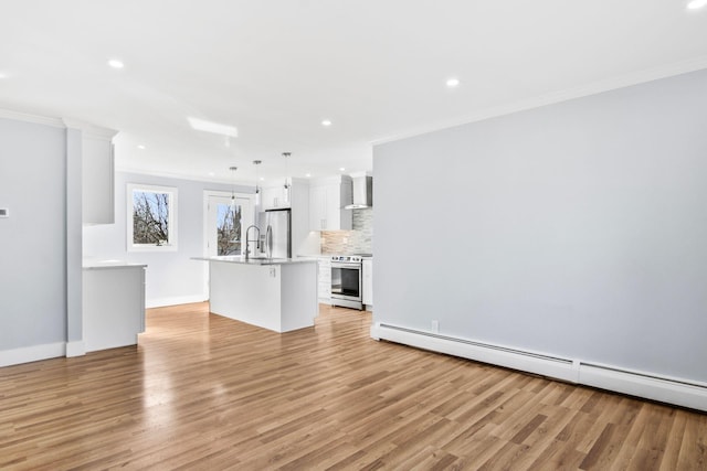 unfurnished living room with a baseboard heating unit, ornamental molding, recessed lighting, light wood-style floors, and a sink