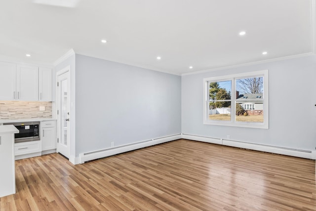 unfurnished living room featuring light wood-style flooring, ornamental molding, recessed lighting, and a baseboard radiator