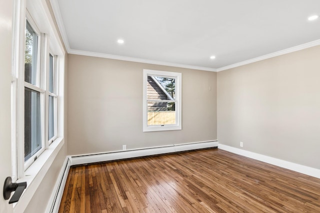 unfurnished room with a baseboard heating unit, wood-type flooring, baseboards, and crown molding