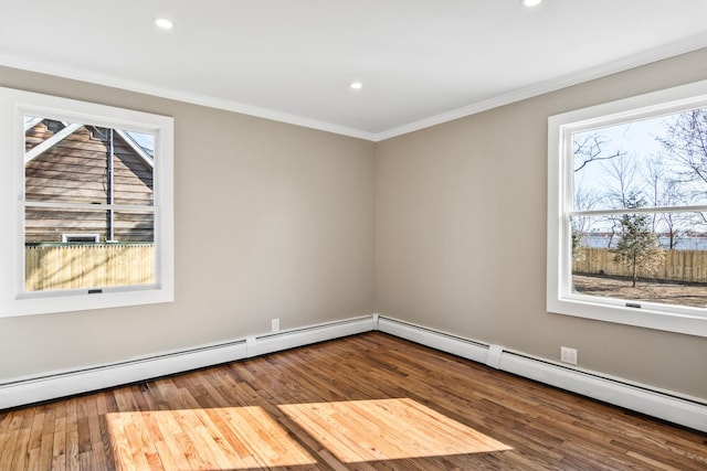 unfurnished room with a healthy amount of sunlight, wood finished floors, and ornamental molding